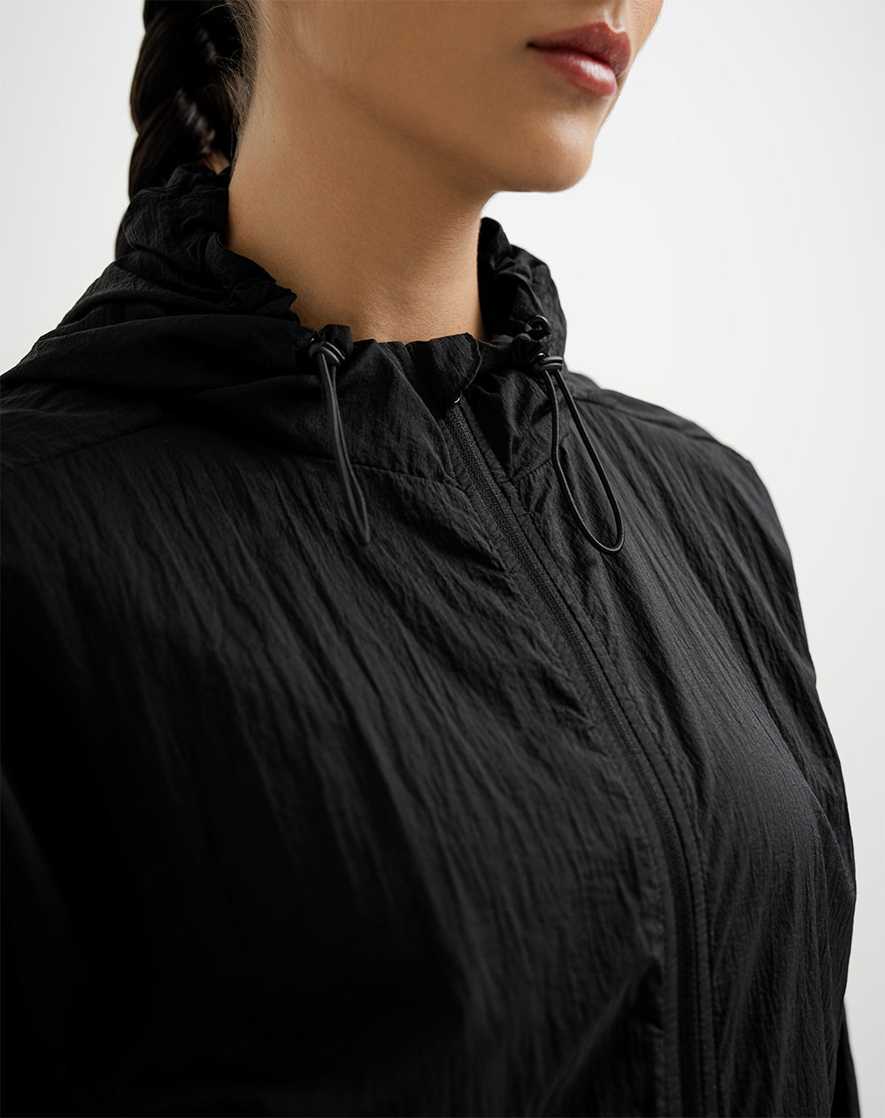 Chaqueta rompevientos con capucha negra para mujer